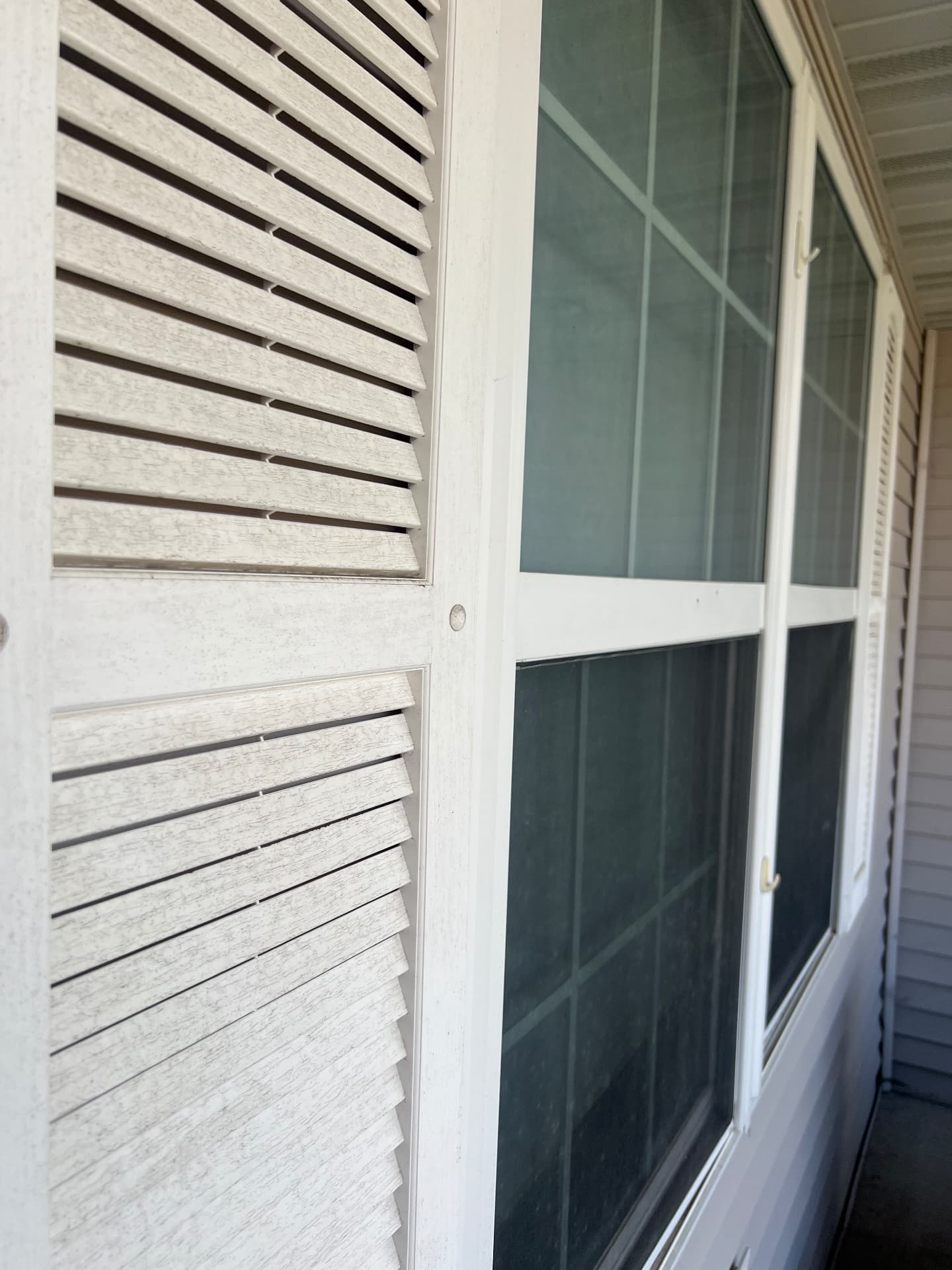 White shutters and window before cleaning