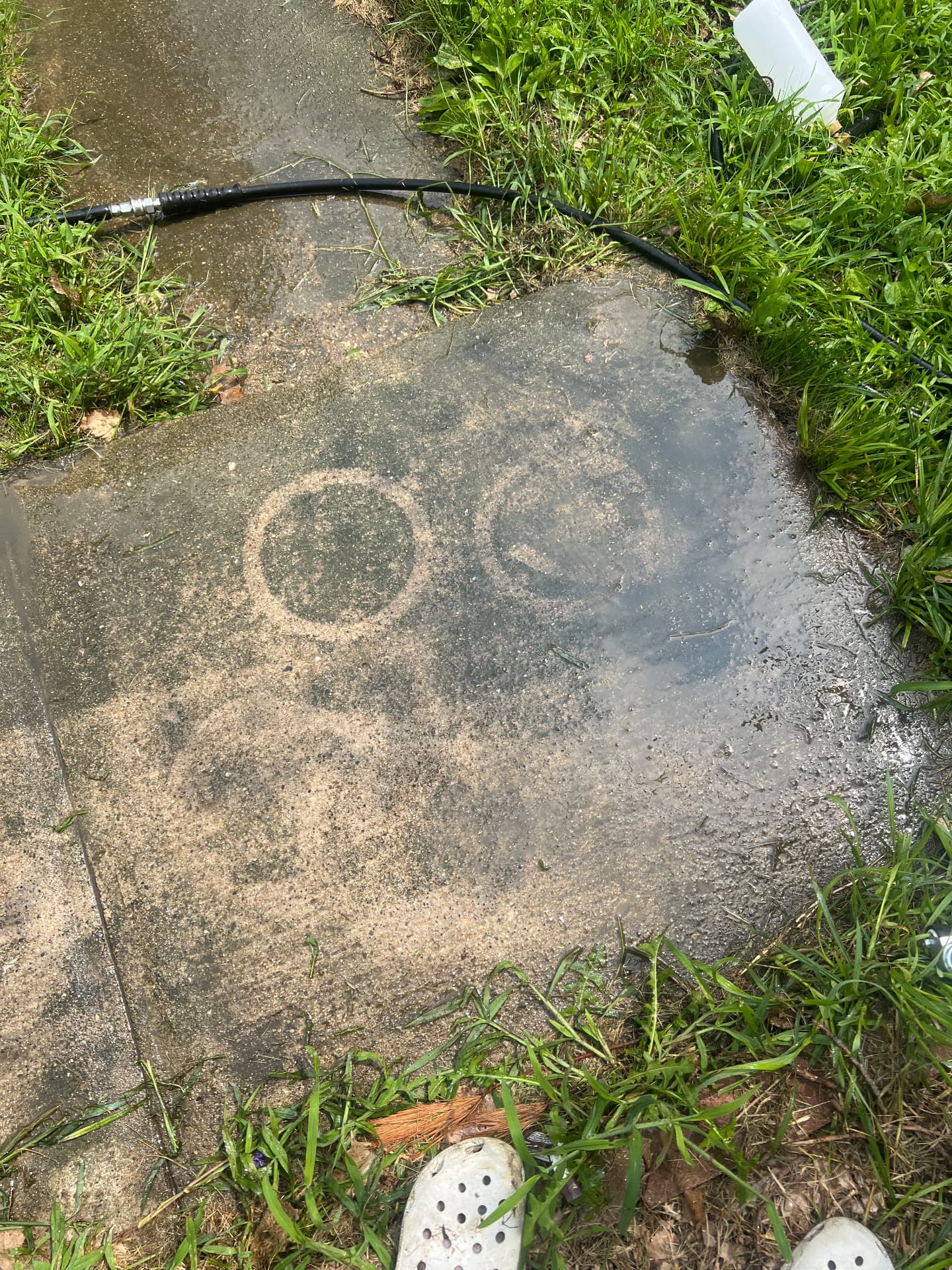 Concrete sidewalk during washing showing the difference in the surface