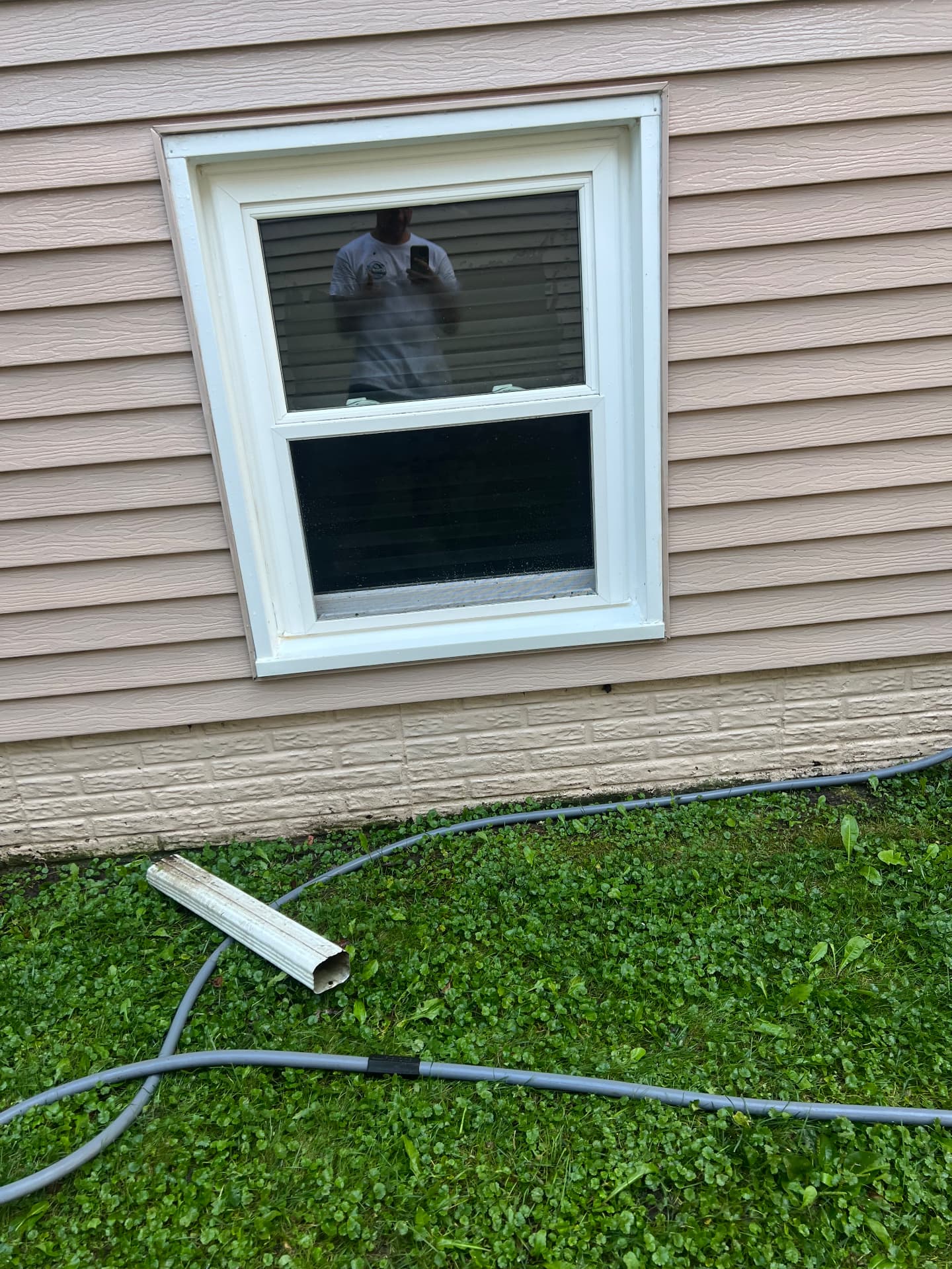 Window frame on tan siding